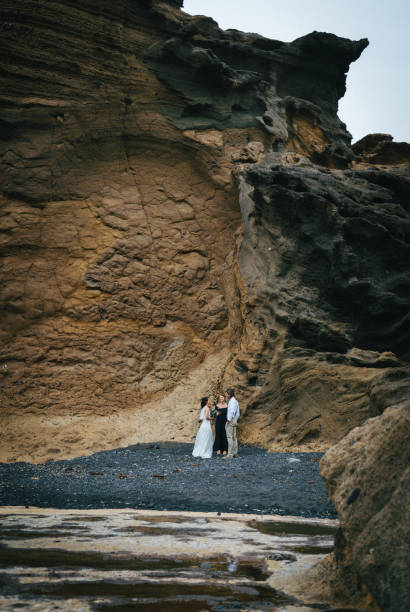 istock View of coastal wedding ceremony on rocky beach 1326325283