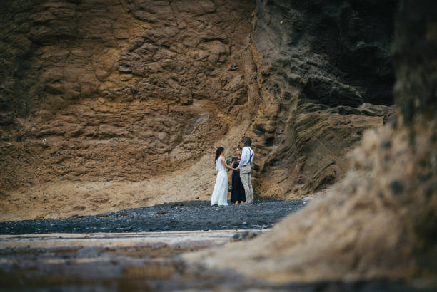 istock View of coastal wedding ceremony on rocky beach 1326325463