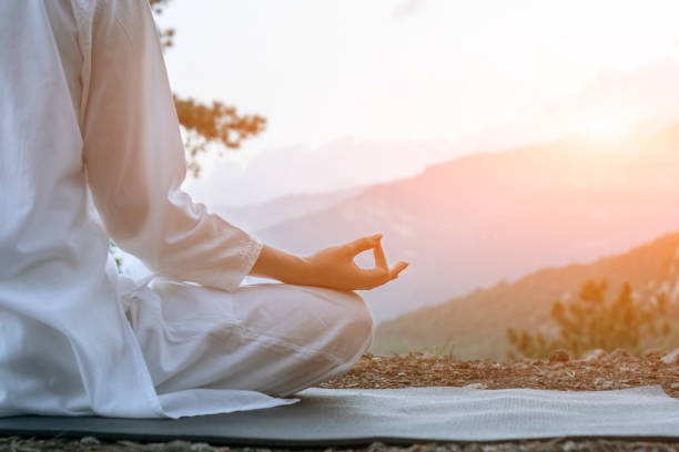 beautiful young woman practices yoga and meditates on the mountain. calmness and unity with nature. - nature human pregnancy color image photography imagens e fotografias de stock