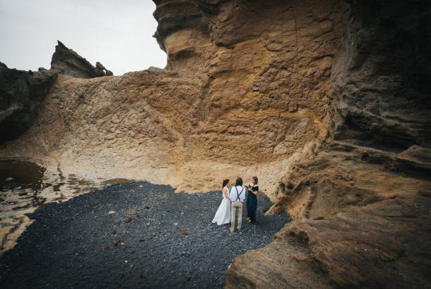 istock View of coastal wedding ceremony on rocky beach 1326326688