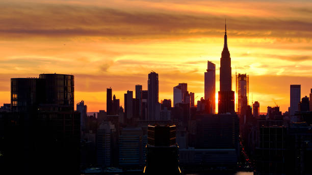 istock Setting Sun Shining Through Buildings Under Construction in Brooklyn and Manhattan - Drone Shot 1326326903