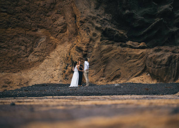 istock View of coastal wedding ceremony on rocky beach 1326327762