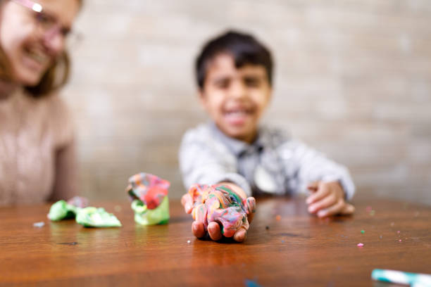 istock Kid showing his art made with modeling clay 1326331395