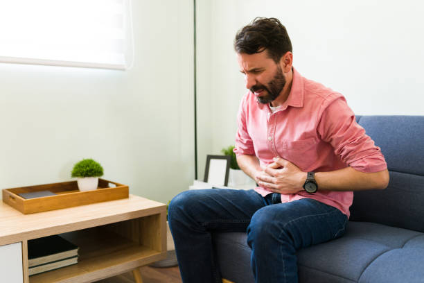 istock Distressed man with a stomach infection 1326331460