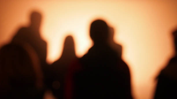 istock Peoples silhouettes on colorful background 1326331954