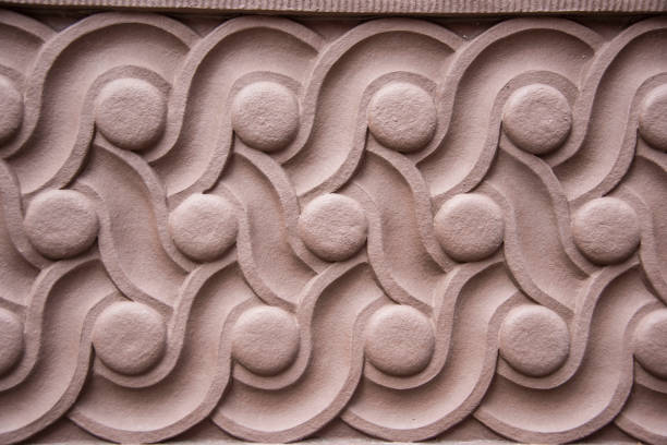 Closeup of terra cotta architectural detail showing geometric swirling pattern