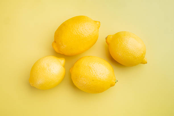 istock Whole ripe lemon, on yellow textured summer background 1326335009