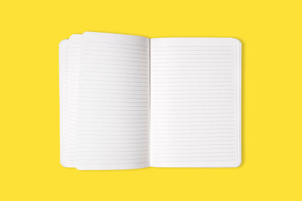istock Blank open office Notepad or notebook isolated on yellow background. Mock up. Top view. 1326337937