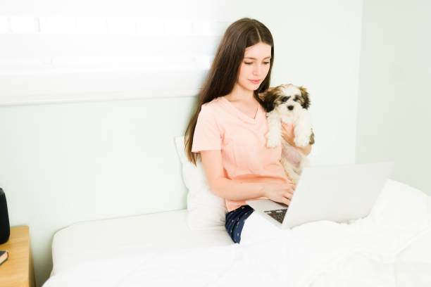 istock Young woman hugging her puppy while working 1326338598