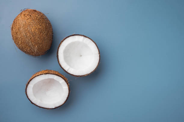 istock Coconut slices, on blue textured summer background, top view flat lay, with copy space for text 1326338762