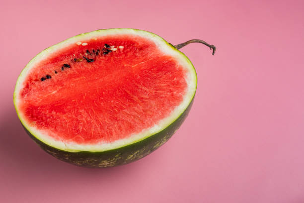 istock Fresh cut watermelon, on pink textured summer background, with copy space for text 1326338783