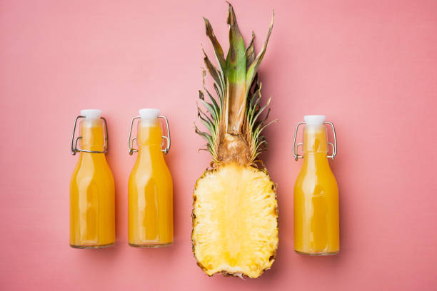 istock Pineapple juice, on pink textured summer background, top view flat lay 1326339728