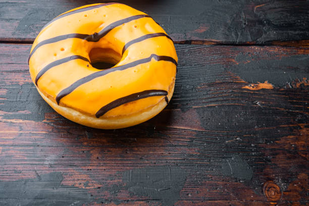 istock Orange Donut, on old dark  wooden table background with copy space for text 1326343660