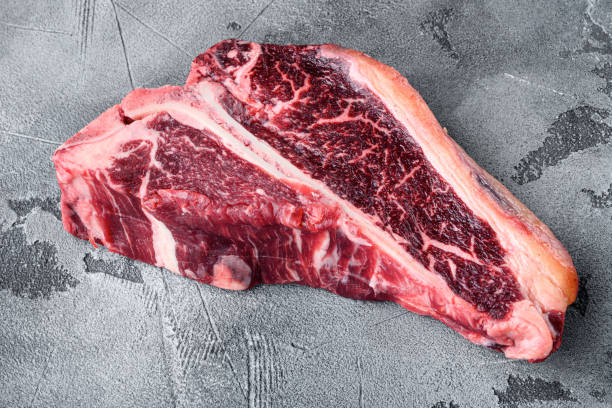 istock Classic fresh beef striploin steaks,T bone cut, on gray stone background 1326344640