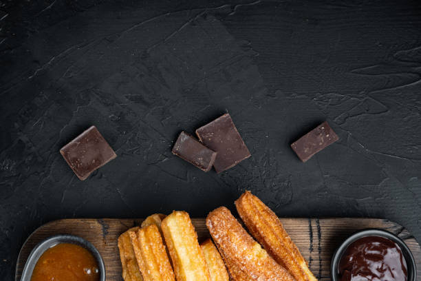istock Churros with chocolate Traditional Spanish cusine, on black background, top view flat lay with space for text, copyspace 1326345449