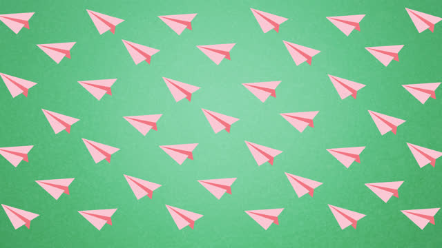 Digital animation of multiple pink paper planes icons floating against green background