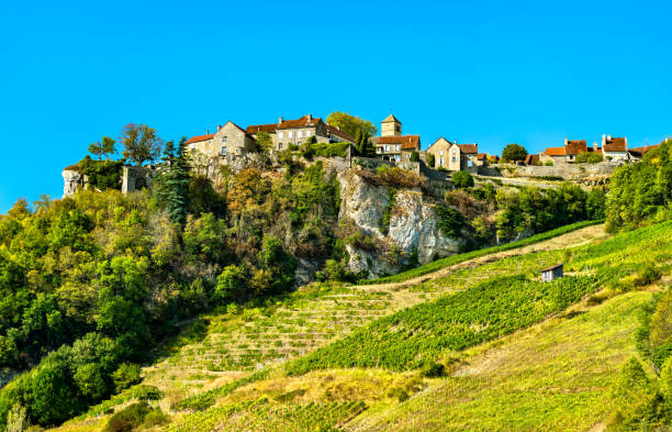 Chateau-Chalon village above its vineyards in Jura, France Chateau-Chalon village above its vineyards in Franche-Comte, France jura stock pictures, royalty-free photos & images