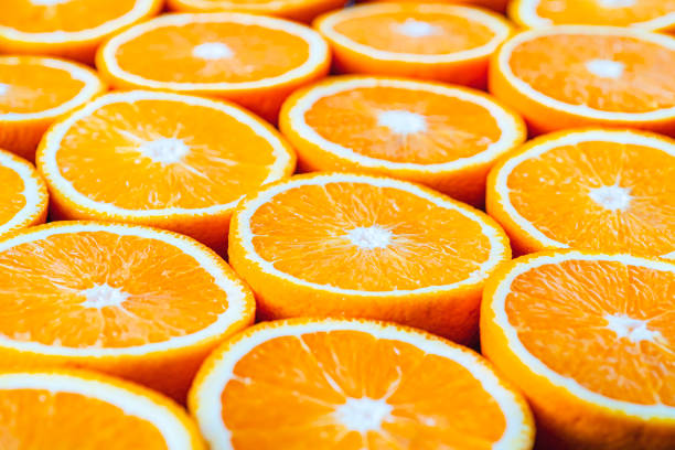 istock oranges or grapefruits are cut in half on black background. close up macro 1326356741