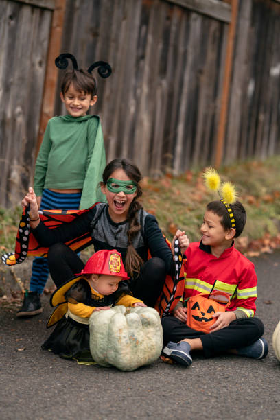 istock Silly siblings trading Halloween costume accessories 1326358529