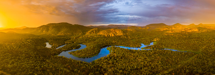 Dunns Swamp panoramic view on the upper cudgegong river NSW Australia at sunset with rain and rainbow