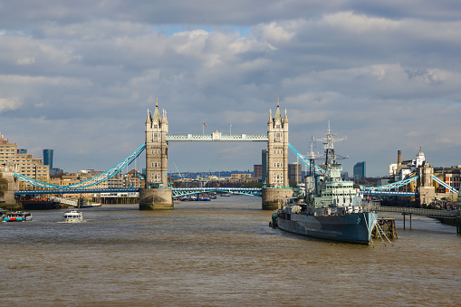 A view of Tower Bridge seen from the middle of the River Thames in London, England. Facing downstream, the South Bank is on the right of the image.