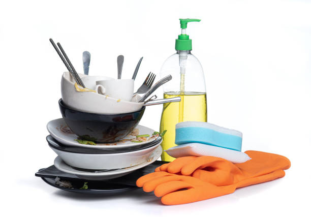 Dirty dishes pile needing washing isolated on white background