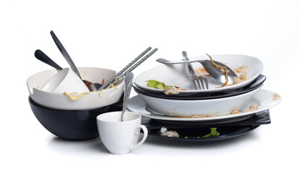 istock Dirty dishes pile needing washing isolated on white background 1326364902