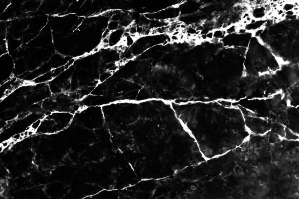 istock White vein cracked patterns of black marble texture background 1326368705