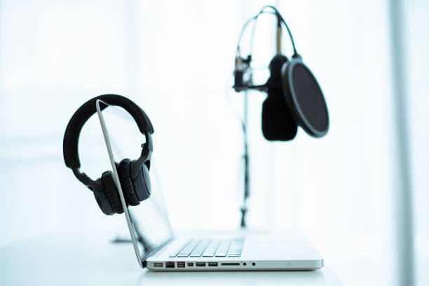 istock Professional condenser microphone and headphones in audio studio. 1326373690