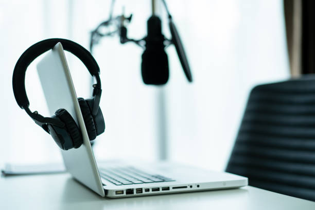 istock Professional condenser microphone and headphones in audio studio. 1326373716