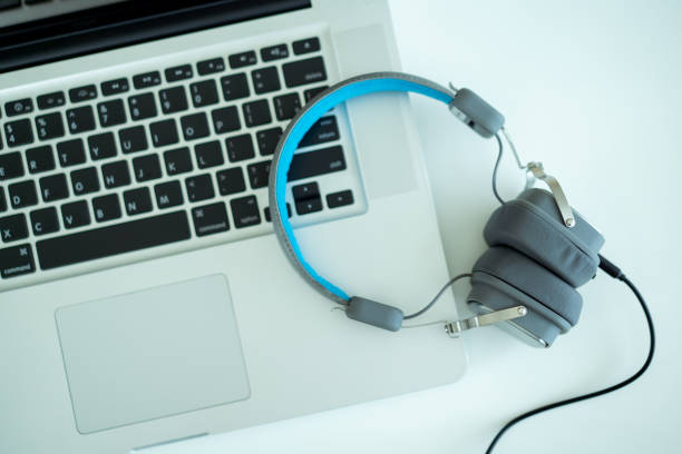istock Professional condenser microphone and headphones in audio studio. 1326373748