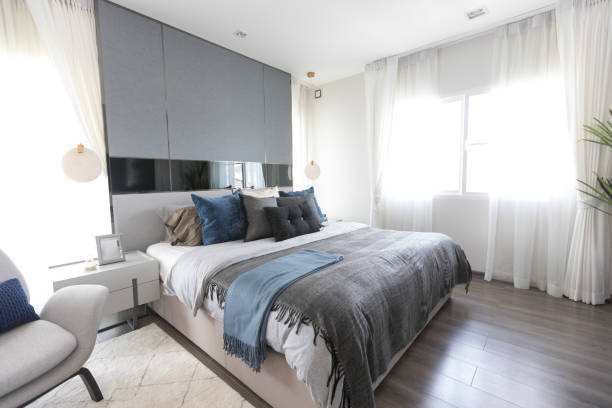 istock Modern white and blue bedroom with armchair 1326373883