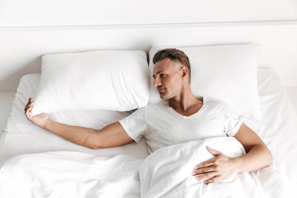istock Sad man laying in bed and looking away 1326379506