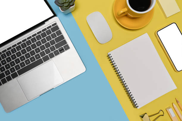 istock Smart phone, laptop computer and coffee cup on two tone blue and yellow background. 1326385863