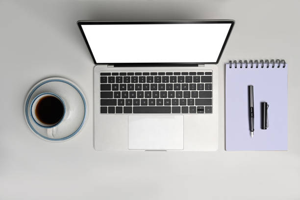istock Overhead shot laptop computer, coffee cup and notebook on white office desk. 1326386771