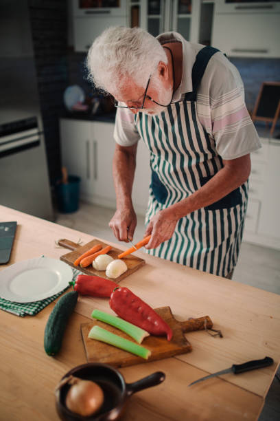 istock Senior man preparing delicious food in the kitchen 1326387678
