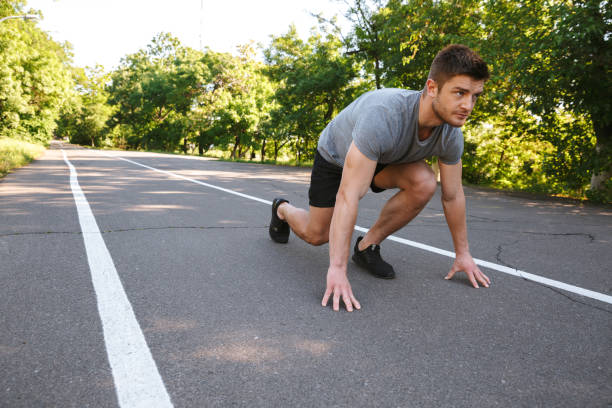 istock Focused sportsman ready to start running on a road 1326387688