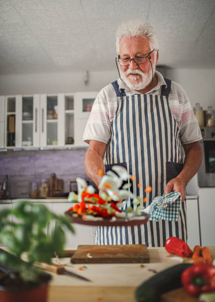 istock Senior man preparing delicious food in the kitchen 1326387859