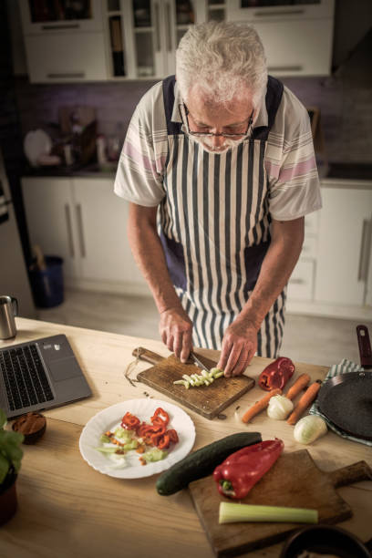 istock Senior man preparing delicious food in the kitchen 1326387861