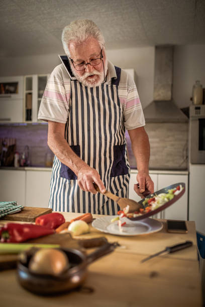 istock Senior man preparing delicious food in the kitchen 1326387879