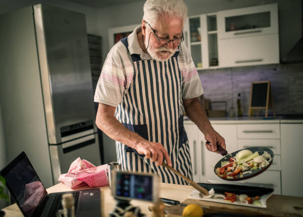 istock Senior man preparing fish in the kitchen 1326388738