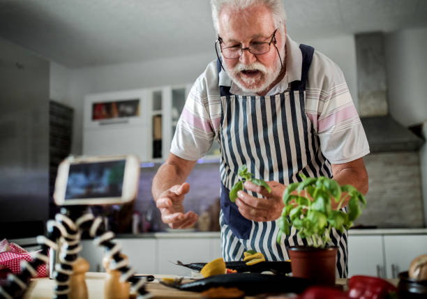 istock Senior man preparing fish in the kitchen 1326389375