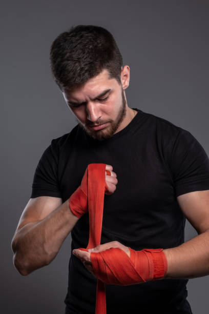 istock Young fighter wrapping hands with cotton tape 1326389722