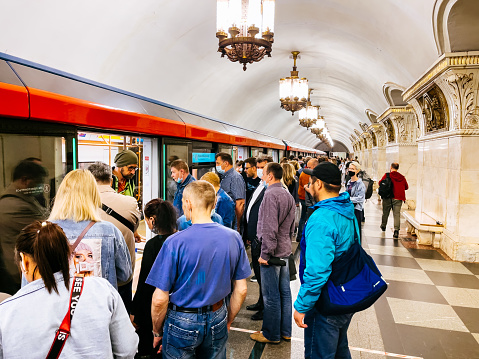 Subway station in Moscow - people are getting on the train.