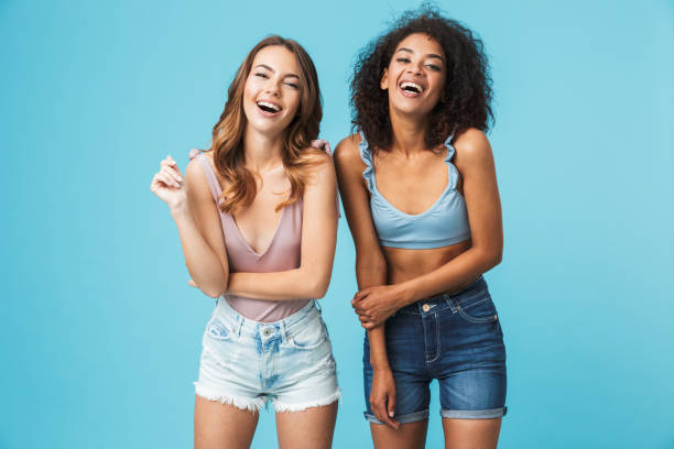 istock Two laughing young girls dressed in summer clothes 1326389878