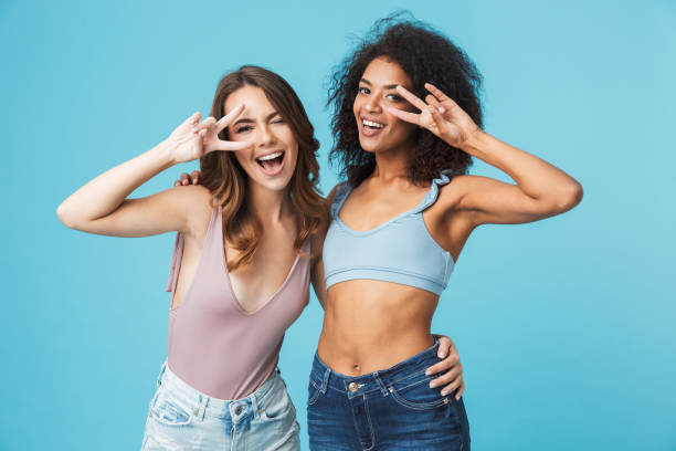 istock Two cheerful young girls dressed in summer clothes 1326390571