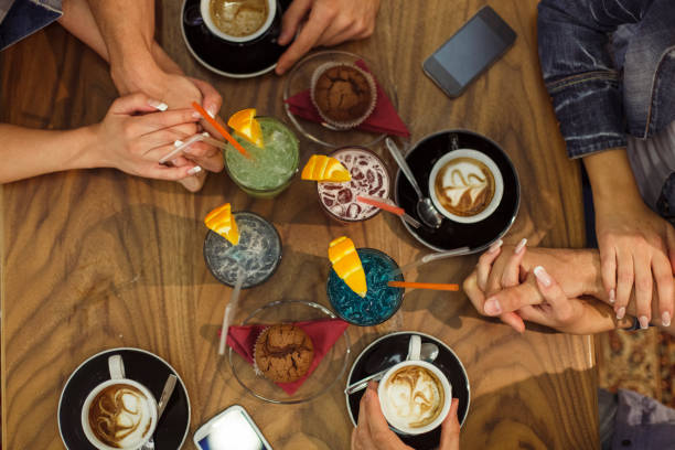 istock Couples on a double date holding hands and enjoying coffee and cocktails 1326390785