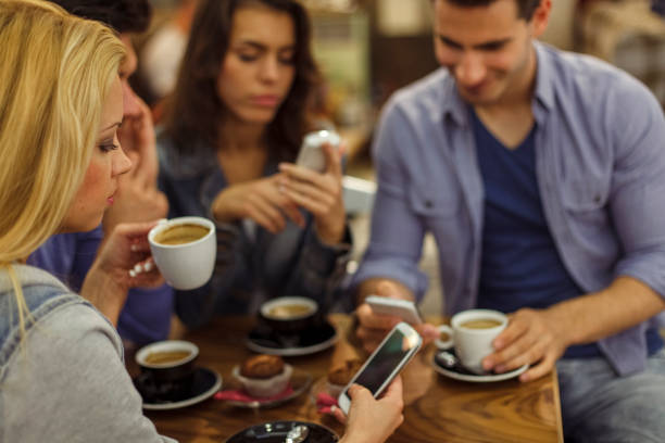 istock Friends checking their smart phones while having coffee at the cafe 1326390813