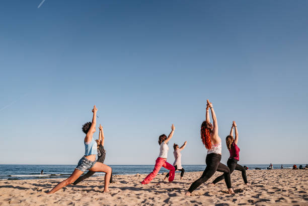istock Group yoga on the beach 1326391452