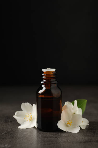 istock Essential oil and jasmine flowers on grey table 1326393940